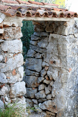 window in the wall of the ancient tower in Cres, island Cres, Croatia