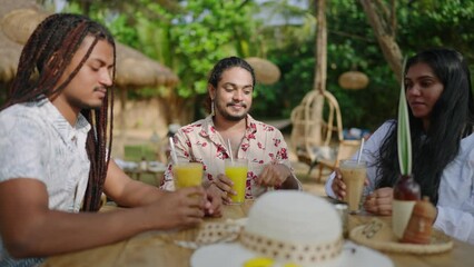 Multicultural friends gather, cheer with drinks at tropical resort. Group toasts, enjoys cocktails, beach vibe. Diverse, joyful faces celebrate unity, friendship outdoors. - Powered by Adobe