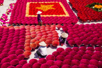Worker drying incense in the Quang Phu Cau incense village, Hanoi, Vietnam