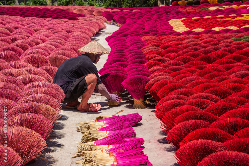 Wall mural Worker drying incense in the Quang Phu Cau incense village, Hanoi, Vietnam