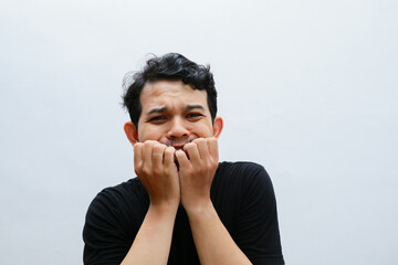 asian man frightened facial expression, covering his mouth