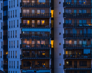 Illuminated Tall Building With Balconies at Night