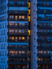 Illuminated Tall Building With Balconies at Night