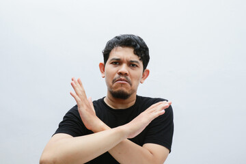 an asian man shows a refusing gesture or a no sign