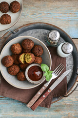 Falafel plate with spice and souce on metal tray - 764037025