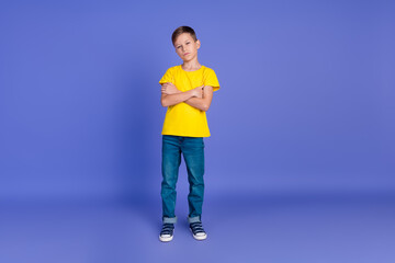 Full length photo of adorable cute small boy wear stylish yellow clothes suspiciously looking...