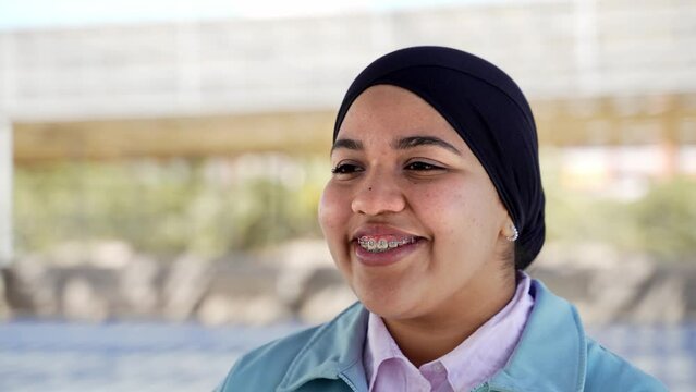 Young Muslim woman confident smiling to the camera. Happy Arab girl portrait.
