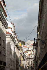 Classical narrow Lisbon street leading toward the hills