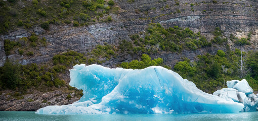 Majestic Blue Iceberg Floating in a Pristine Lake