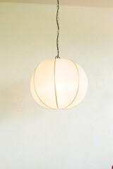 White Japanese lantern hanging at restaurant.