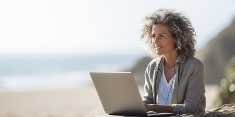 Attractive mature woman 50-60 makes use of laptop on the seashore, active elderly people, Generative AI.