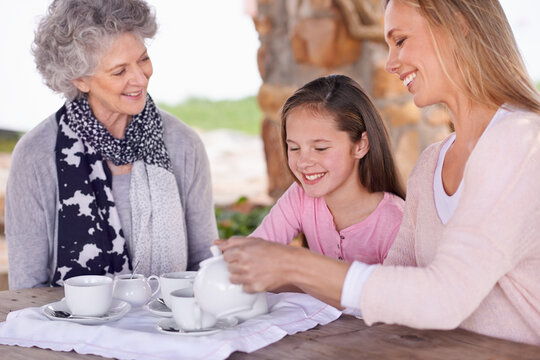Woman, child and relax with tea for fun, generations in park together for bonding with love. Family time, mother and happy grandma and smile for summer garden picnic, cups and teapot for beverage - Powered by Adobe