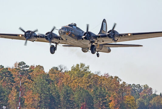 B-17 "Flying Fortress" bomber taking off over trees