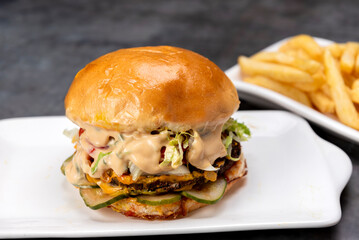 variety of vegan and vegetarian beef burgers casserole with onion cucumber dressings tomato chedar cheese lettuce mayonnaise mustard ketchup barbecue legumes with potato bread and French fries 
