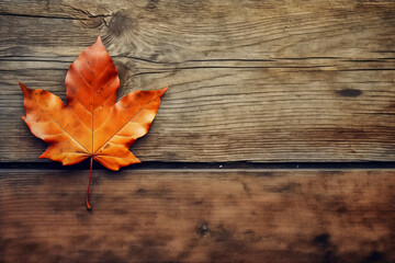 Naklejka na ściany i meble Yellow autumn leaf on wooden background. Top view, copy space.