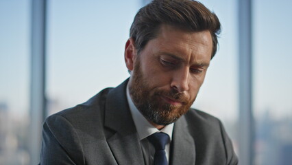 Serious businessman drink coffee in panoramic office closeup. Pensive man rest