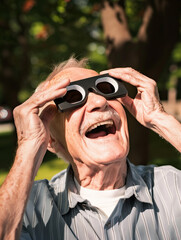 Excited senior man looking at solar eclipse and wearing protective solar eclipse glasses
