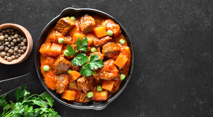 Beef stew with potatoes and carrots in tomato sauce