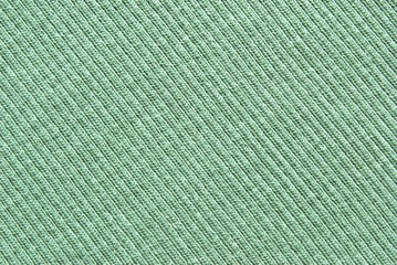 Soft light green color ribbed jersey fabric pattern close up as background