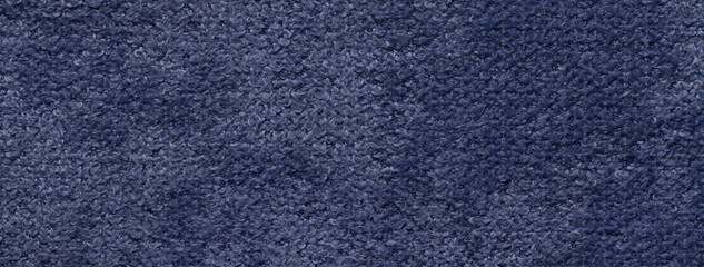 Texture of navy blue background from soft fluffy upholstery textile material, macro. Abstract dark denim fabric.