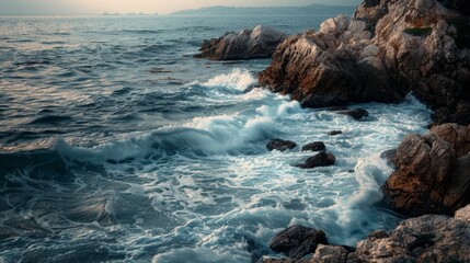 Waves crashing on rocky shore at sunset