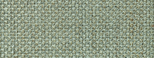 Texture of light green color background from woven textile material, macro. Structure of vintage olive fabric