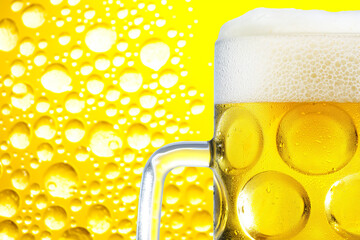 A close-up of a mug of beer with a yellow background, filled with bubbles.