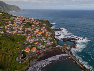 Aerial view of Seixal, a little village by the ocean with waves and surrounded with incredible...