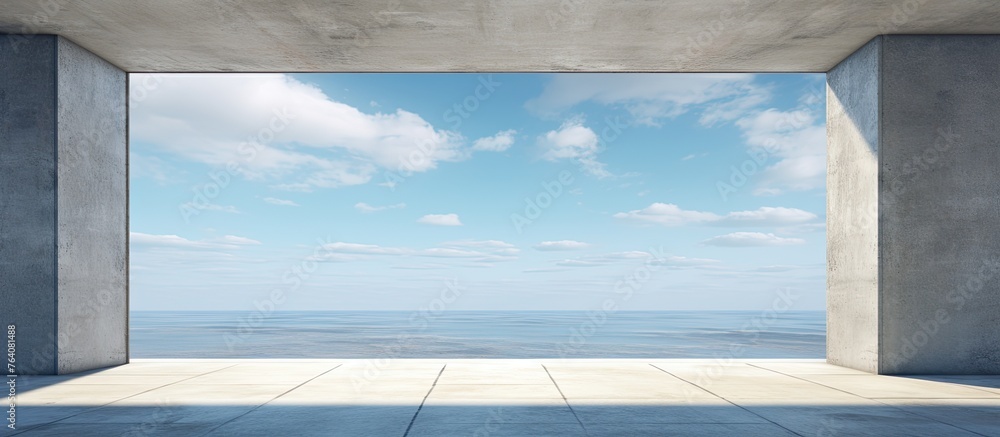 Poster an expansive room with a large open space and windows offering a panoramic view of the ocean