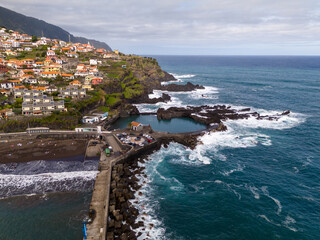 Aerial view of Seixal, a little village by the ocean with waves and surrounded with incredible...