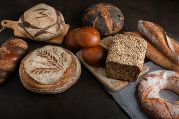 Top view of select homemade sourdough bread. Fresh Sourdough bread on a black table. Flat lay.
