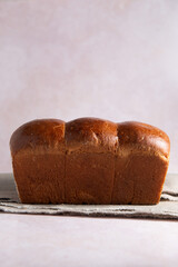 Fresh baked homemade hokkaido Bread loaf with copy space. Side view.