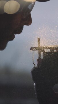 Find tranquility in the art of woodworking as our 4K vertical slow motion video captures the serene act of a craftsman blowing sawdust from his saw. Ideal for showcasing the peace and mindfulness foun