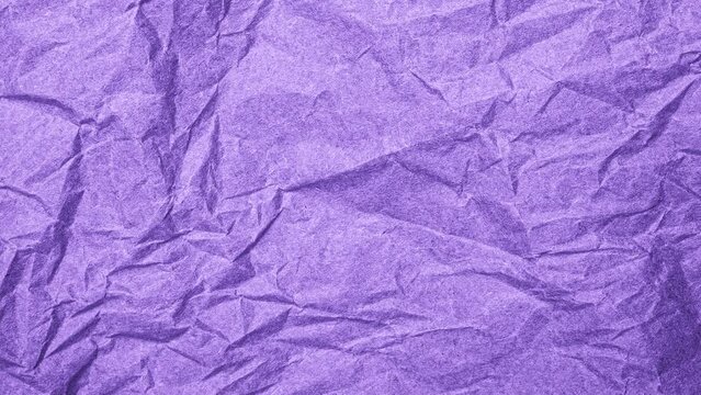 Video background of purple crumbled paper. Video Top view of wrinkled textured paper. Violet crumpled paper texture background. Wrinkled, abstract paper background