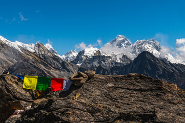 View of snow capped Everest, Nuptse and Lhotse mountains of the Himalayas during EBC Everest Base Camp or Three Passes trekking. View from Gokyo Ri with buddhist prayer flags, Solukhumbu, Nepal.