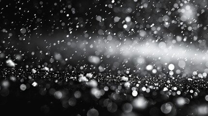 The falling snow of winter is isolated on a pure black background.