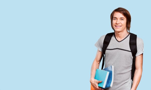 young teen student with backpack on color background