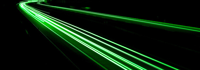 green car lights at night. long exposure