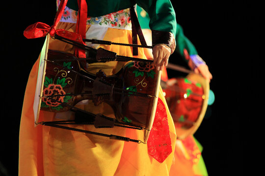 Korean traditional percussion janggu performance. female dancers performing janggu wearing hanbok.