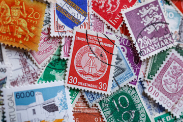 Ukraine, Kiyiv - January 12, 2023 A Stamp printed in German Democratic Republic.Postage stamps.A collection of world stamps in a pile.Postage stamps from different countries and times