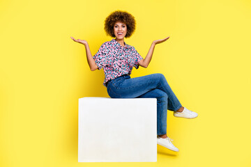 Full length photo of good mood excited woman wear shirt sitting cube showing scales empty space...