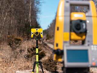 land surveying total station instrument on a tripod in the field