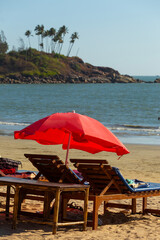 Vacationers under colorful umbrellas on the ocean shore - 764097006