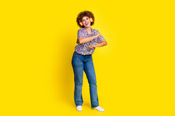 Full length photo of funky cool woman wear animal print shirt dancing enjoying music headphones isolated yellow color background