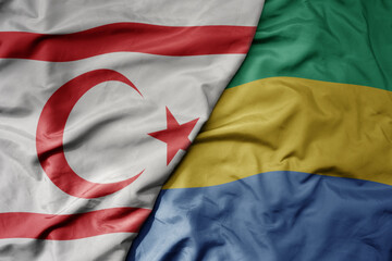 big waving national colorful flag of gabon and national flag of northern cyprus.
