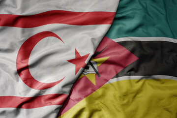 big waving national colorful flag of mozambique and national flag of northern cyprus.