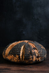 Sourdough bread. Freshly baked organic wheat bread on a dark background. 