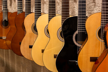 Group of acoustic guitars in a music shop. Musical instruments for sale.