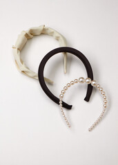 three stylish women's headbands on a light background