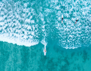 Surfer on waikiki beach from a drone